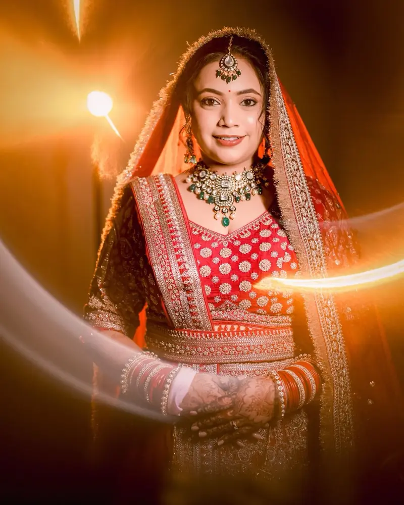 A bride in red smiles inside a warm ring of light