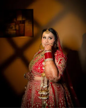 Gauri looks up, hand to her lips, framed by warm window shadows