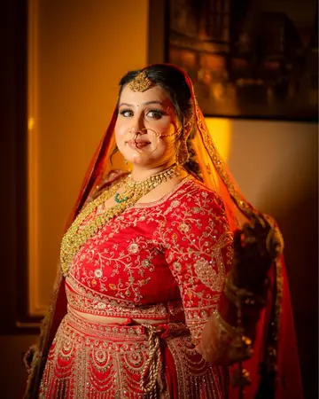 Gauri smiles over her shoulder, lamplight catching her jewellery